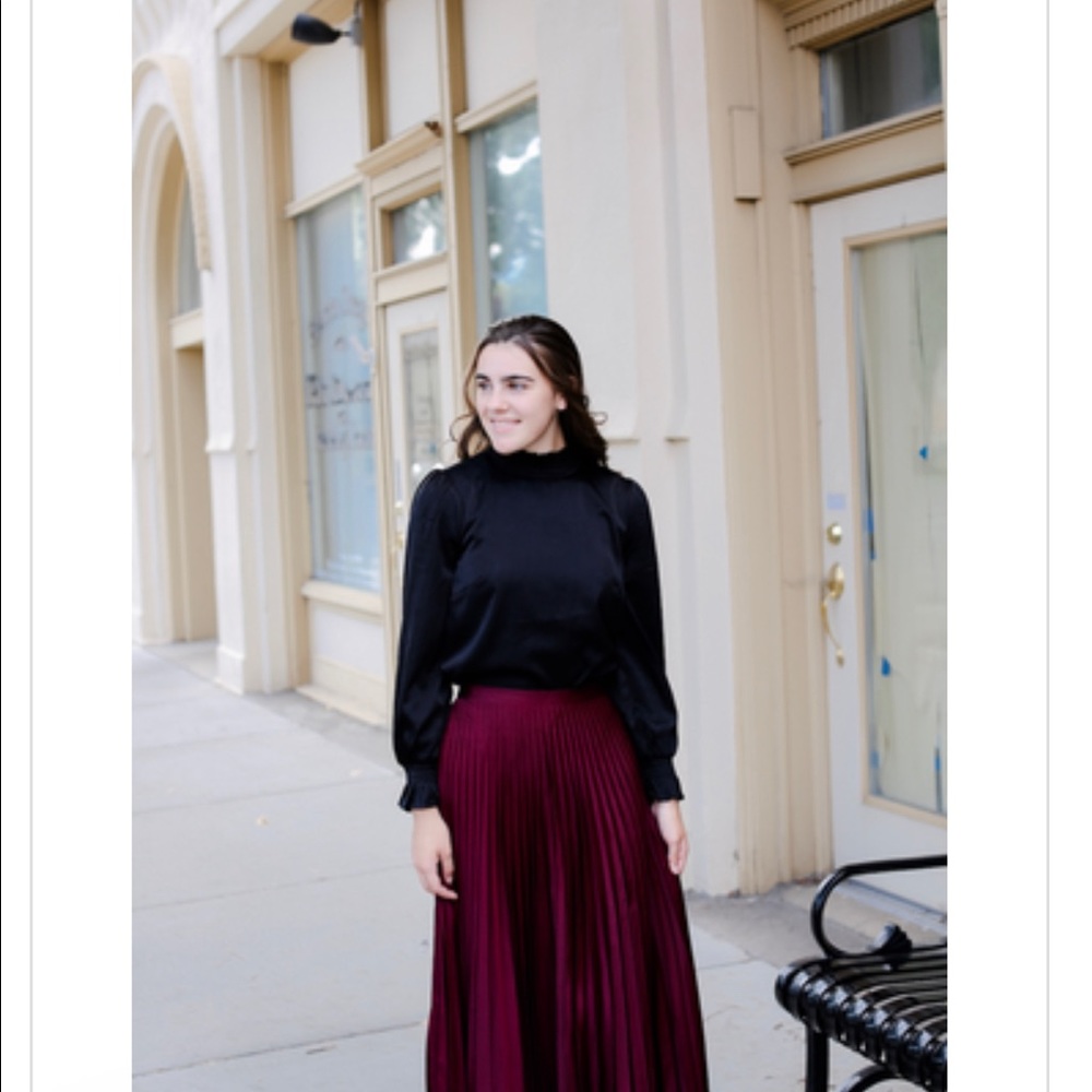 Dainty Jewell striking in satin blouse